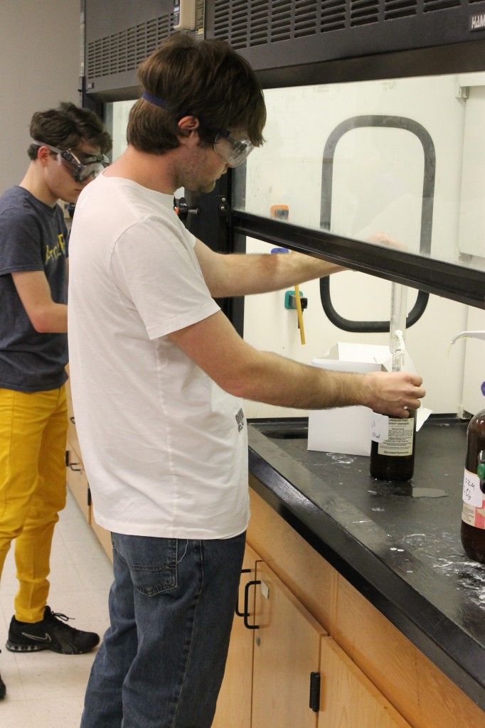 Sophomore Nick Kowalkowski performs a lab experiment in General Chemistry. Photo by Zac Baker.