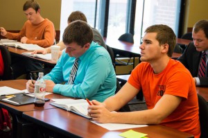 Seniors Josh Reaper (left) and Ethan Blackmon (right) take notes while listening to a lecture in their Institutional Accounting class. Photo by Alex Becerra.