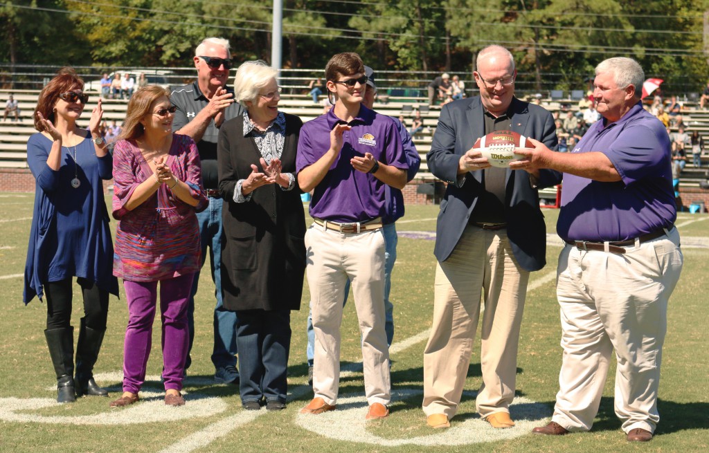 Athletic Director David Sharp (far right) recognized Rex Nelson for his service to Ouachita Football at halftime of Ouachita's Oct. 3 Homecoming game. Photo by Grace Finley.