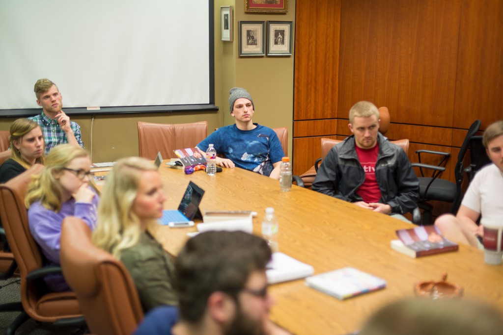A group of students listen attentively to Dr. Motl in Modern Government, one of the many courses offered in the School of Social Sciences.