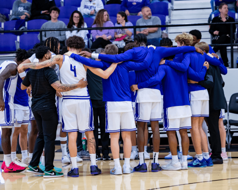 The team huddled up to hear the game plan from coach | Photo by Joshua Rhine